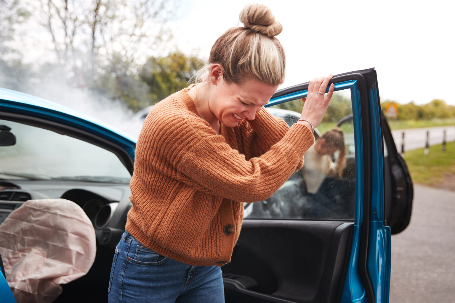 A lady in emotional distress after a car accident